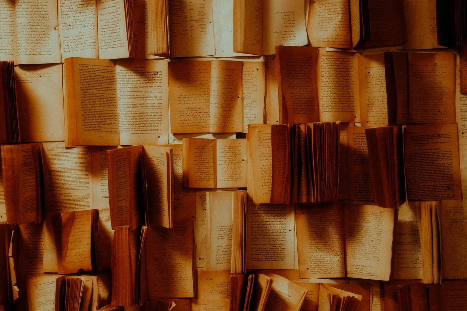 Des livres ouverts dont les pages forment une paroi dorée